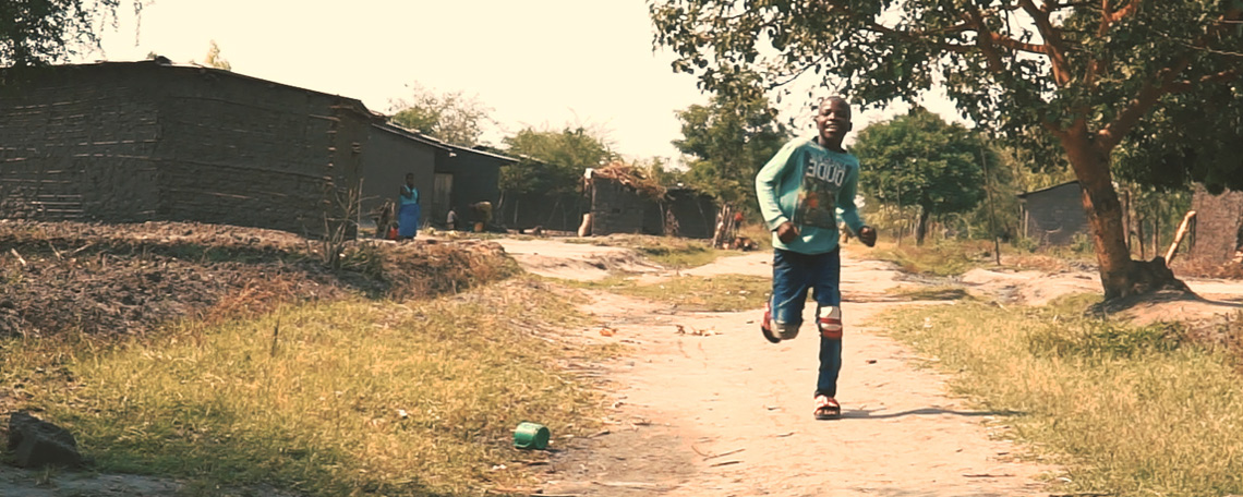 Issa running joyfully in his home village